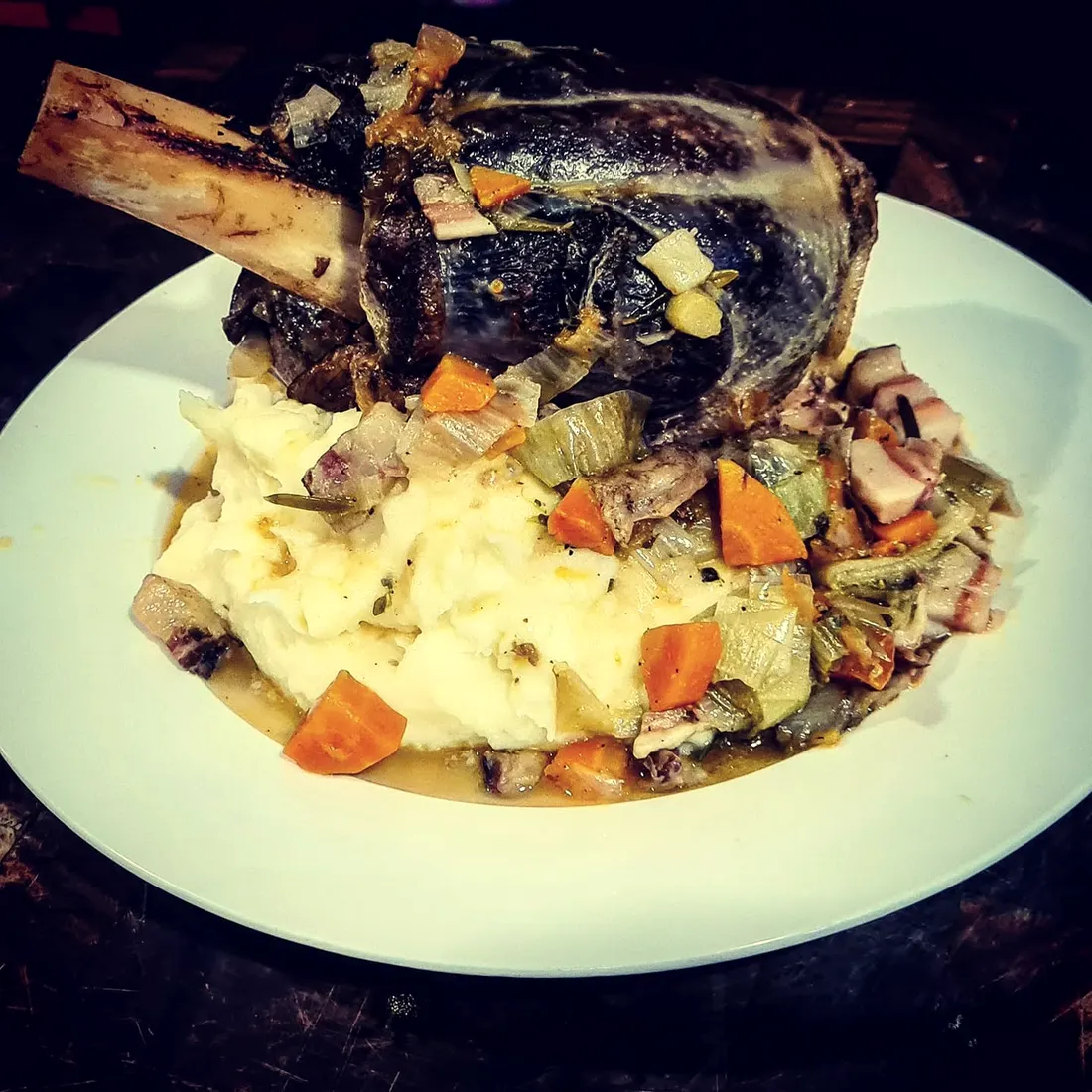 A slow-cooked shank served with mash